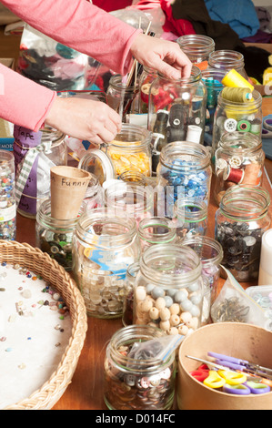 jars  of different types of buttons and accessories for sewing Stock Photo