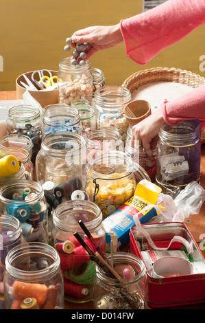 jars  of different types of buttons and accessories for sewing Stock Photo