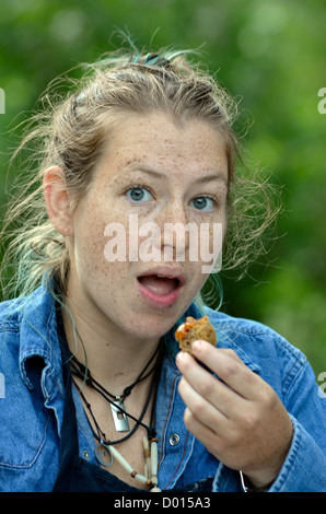 Woman with freckles eating. Stock Photo