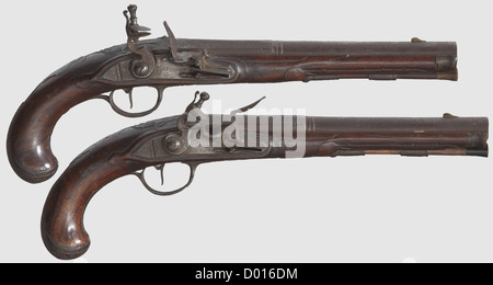 A pair of German flintlock pistols,I. P. Meyer in Braunschweig,circa 1760. Two-stage barrels,octagonal then round after a girdle with smooth bores in 13 mm calibre,modest vine engraving on upper side and each of them marked 'A Bronsvic'. Flintlocks,signature on lock plates,one lock with faulty notch. Carved walnut full stocks with horn noses and iron furniture. Escutcheons with coats of arms. Wooden ramrods with horn tips. Length 35 cm each. A pair of pistols in untouched condition,can be improved by cleaning,historic,historical,18th century,civil ha,Additional-Rights-Clearences-Not Available Stock Photo