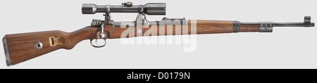 A scope rifle 98 k,Mauser,with high top-hinged mount and scope ZF Ajack,cal. 8 x 57,no. 5713. Matching numbers. Almost bright bore. Receiver head covered by front mount socket,but various acceptance marks eagle/'135' and barrel root marked '44D' which means produced at Mauser's,Oberndorf,at the end of 1944,beginning of 1945. Thin,spotted finish. Chamber thinly grey phosphatised,milled-off safety catch(replaced),matching-numbered firing pin,round gas release holes,without action spring guide. Sheet steel-stamped floorp historic,historical,1930s,,Additional-Rights-Clearences-Not Available Stock Photo