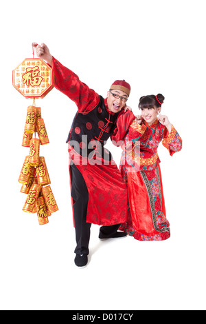 Happy young couple in Traditional clothing igniting fireworks Stock Photo