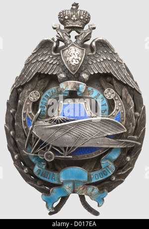 A Standard Flyer's Badge,Russia circa 1914. Silver,fashioned in multiple sections,enamelled areas. Interlaced bandeau(chipped)with Cyrillic inscription(tr)'Russia's Strength - Aviation'. Reverse Cyrillic master's mark 'VA',kokoschnik punch as well as fineness punch for '84' zolotniki. Pressure plate with maker's mark 'Eduard',master's mark 'VA' and kokoschnik head punch. Dimensions 70 x 46 mm,weight 59 g. Fine quality,historic,historical,1910s,20th century,medal,decoration,medals,decorations,badge of honour,badge of honor,badges of honour,,Additional-Rights-Clearences-Not Available Stock Photo