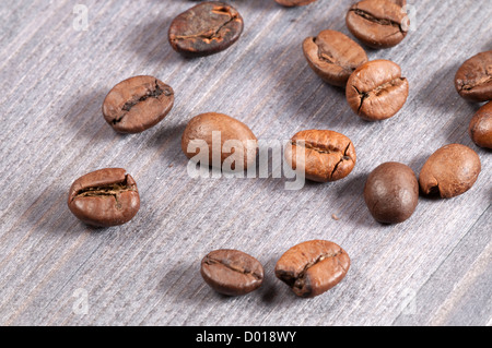 Coffee beans on an old wooden table, close-up Stock Photo