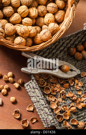 Different kinds of nuts in wicker baskets Stock Photo