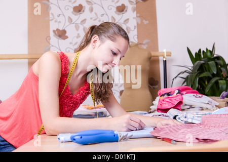 a young female couturier in the workroom Stock Photo