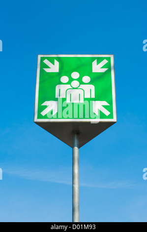 emergency assembly point green sign against a blue sky Stock Photo