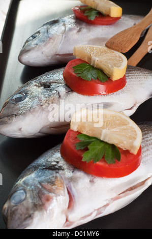 Fresh Sea Bream fish close up with vegetables Stock Photo
