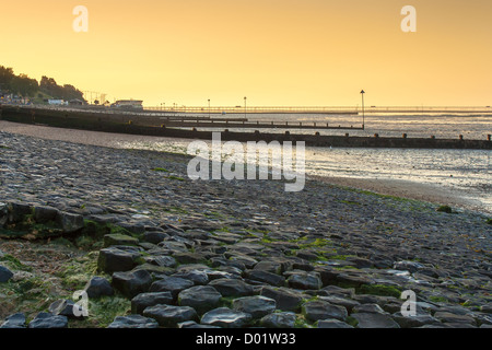 view across southend beach at sunrise with pier on the horizon Stock Photo