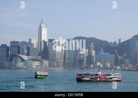 Asia, Hong Kong. Hong Kong Island city skyline view from Victoria Harbor. Kowloon ferry boat. Stock Photo