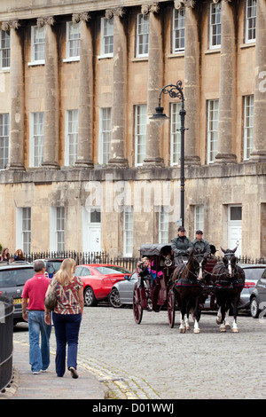 people look at a traditional 18th century horse and carriage in Royal Crescent, Bath Somerset UK Stock Photo