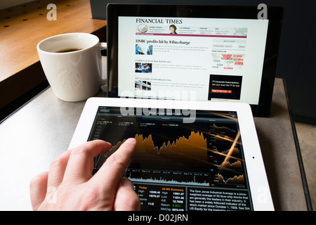 Detail of Microsoft Surface rt tablet computer and iPad 3 with stock market financial data app on screen Stock Photo