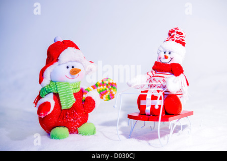 Two happy snowmen smiling at each other. Stock Photo