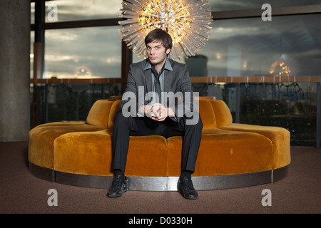 Young corporate executive sitting in luxurious interior Stock Photo