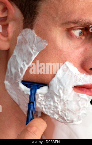 Man whet shaving in side view Stock Photo