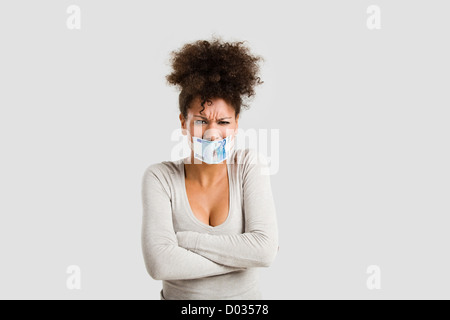 African woman covering her mouth with a euro banknote, great concept for the global crises Stock Photo