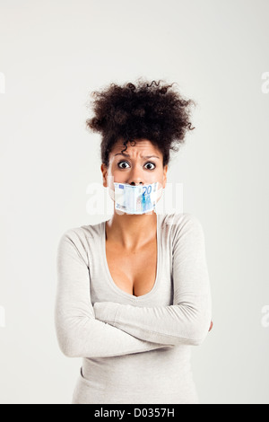 African woman covering her mouth with a euro banknote, great concept for the global crises Stock Photo