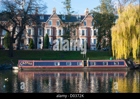 House boats and barges moored on the River Cam at Jesus Green Cambridge UK in beautiful autumn sunshine Stock Photo