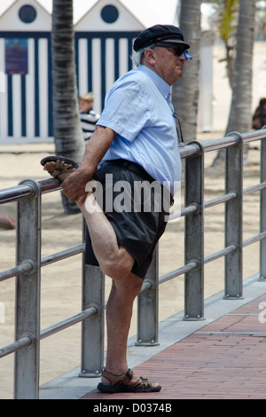 old man doing stretching exercises Stock Photo