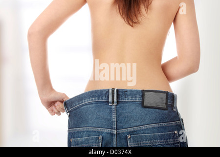 Woman showing how much weight she lost. Stock Photo