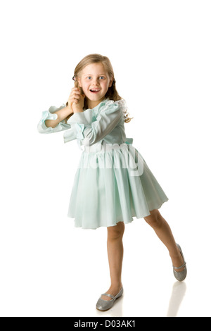 Cheerful girl spinning on floor isolated on white Stock Photo