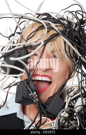 Mature businesswoman's screaming in cables. Stock Photo