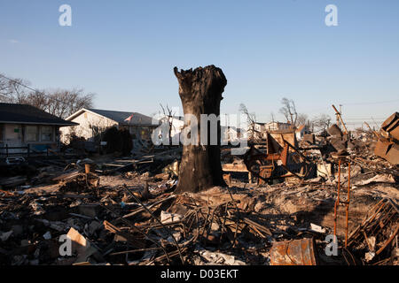 November,14th, 2012, New York, NY, USA : Two weeks after Hurricane Sandy helped a fire burn over eighty houses to the ground, Breezy Point still has the appearance of a devastated war zone. Local residents have begun the daunting task of rebuilding and clearing the damage caused by the storm Stock Photo