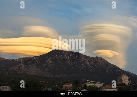 Lenticular clouds forming at sunset over the Taygetus mountains, in the Outer Mani, Peloponnese, Greece. Stock Photo