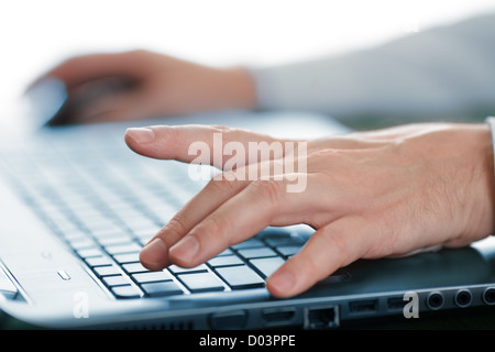 Hands typing on laptop keyboard Stock Photo