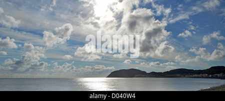 Dramatic blue sky & clouds morning seascape & sunrise view from Llandudno seafront towards Little Orme headland Llandudno Conwy Clwyd North Wales UK Stock Photo