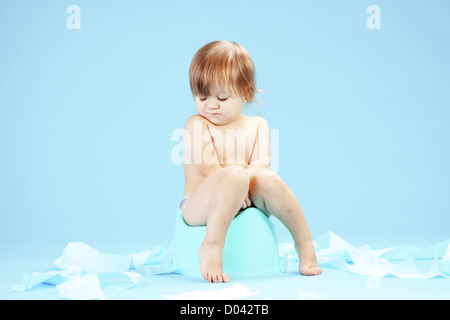 Cute toddler on potty chait Stock Photo