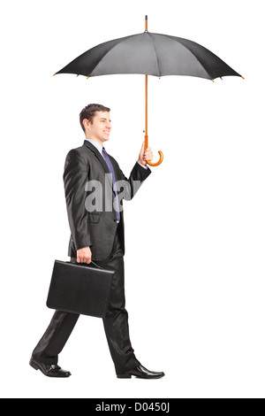 Full length portrait of a man holding an umbrella and briefcase isolated on white background Stock Photo