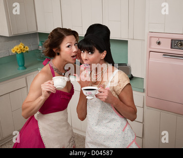 Two middle-aged retro styled women gosipping while having coffee Stock Photo