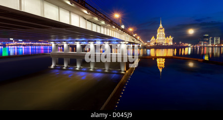 Night Moscow. Moscow River. A kind from Krasnopresnenskaya quay on hotel Ukraine and on the New Arbat bridge. Panorama. Stock Photo