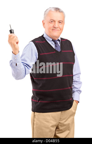 Smiling mature gentleman holding a car key isolated on white background Stock Photo