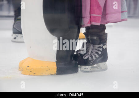 16th November 2012. London UK. Children learn to skate on the ice with the aid of a penguin as Somerset House transforms its grounds into an ice rink which is open to the public for winter Stock Photo