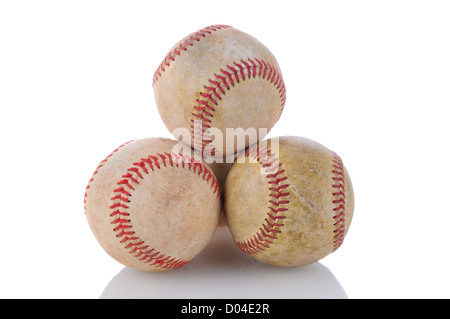 Closeup of a stack of well used baseballs. Horizontal format on a white background with reflection. Stock Photo