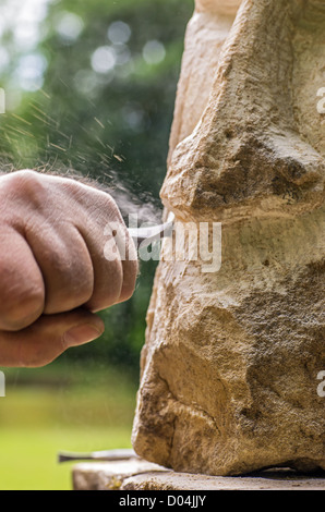 sculptor working on a stone sculpture Stock Photo