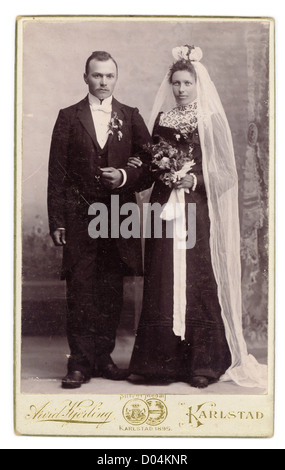 Antique 1895 Wedding Photo Bride in Black Dress & Groom in Tuxedo Stock Photo