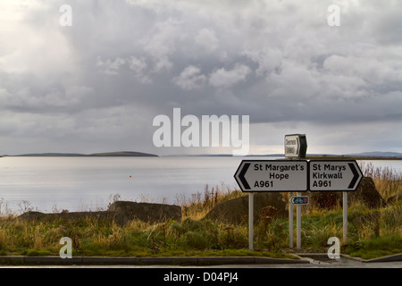 Signposts at the start of Churchill Barrier No1 leading from the Orkney mainland to the island of Lamb Holm in Scapa Flow. Stock Photo