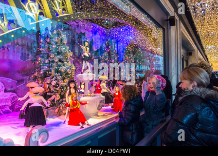 Paris, France, Families Looking, French Department Store Le Printemps, Dior Shop Front WIndow, Enjoying Christmas Lights Decorations, Display at Night, christmas shop window paris, Families at christmas Stock Photo