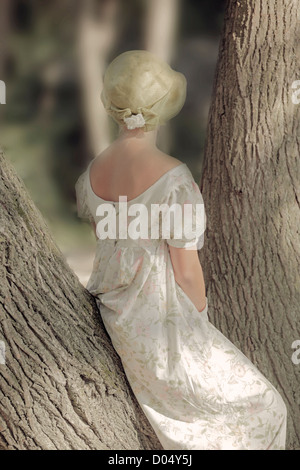 a woman in a floral dress is sitting on a trunk Stock Photo