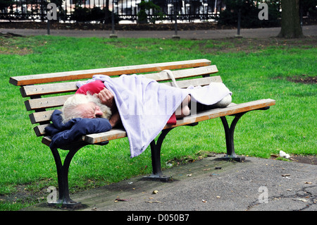 Homeless man sleeping in a park bench Stock Photo - Alamy