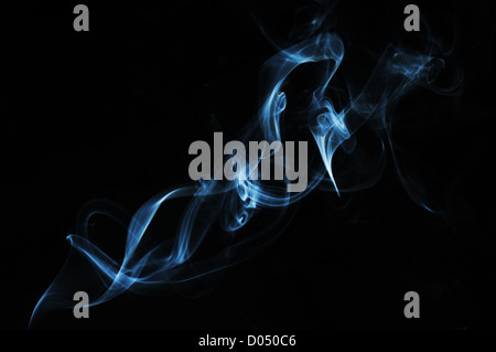 wisp of cigarette smoke on black background Stock Photo