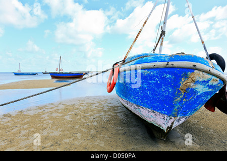 Dhows lie stranded on the sand bank at low tide on Inhaca Island in Mozambique Stock Photo