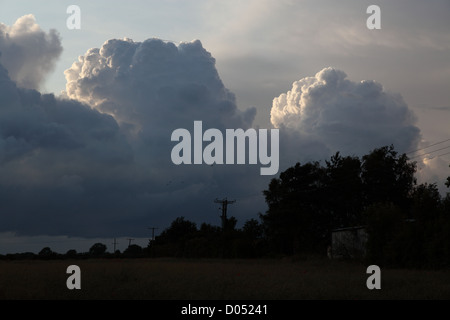 threatening cumulonimbus clouds seen in the UK in the late summer evening threatening a summer storm Stock Photo