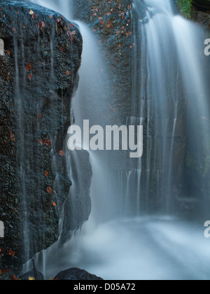 waterfall spray splashing on rocks Stock Photo