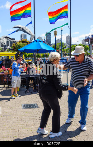 San Francisco - Fisherman's Wharf, Pier 39. Older couple dancing to street entertainer. Stock Photo