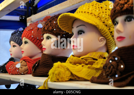 Head mannequins displaying hats and scarves on a market stall Stock Photo