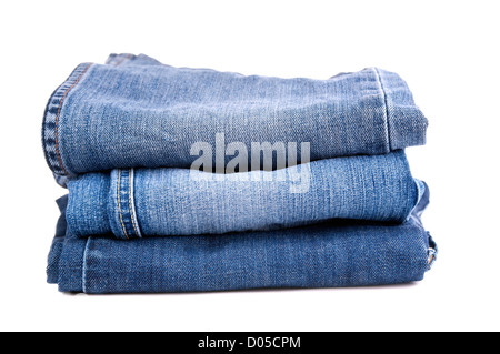 Blue jeans folded and stacked together, isolated on white Stock Photo